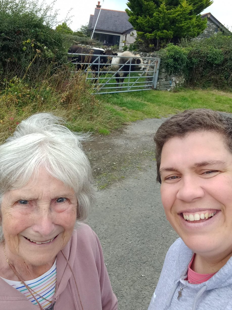 Elderly woman, Maureen on a walk with the staff at knitting club